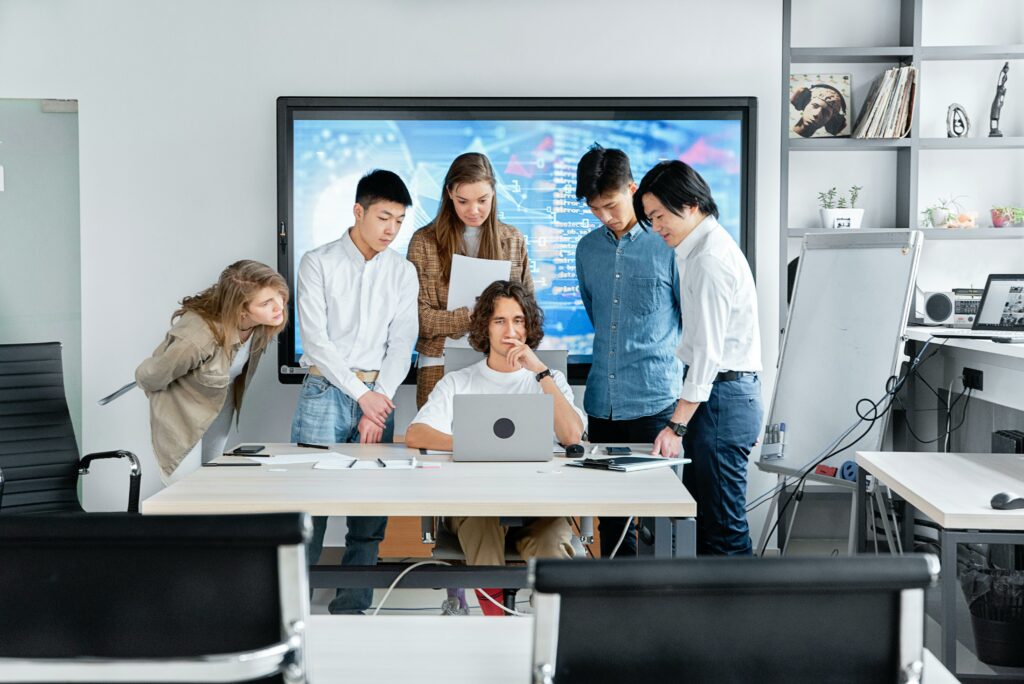 pexels-photo-7988218-7988218 Diverse team collaborating on a software project in a contemporary office setting.